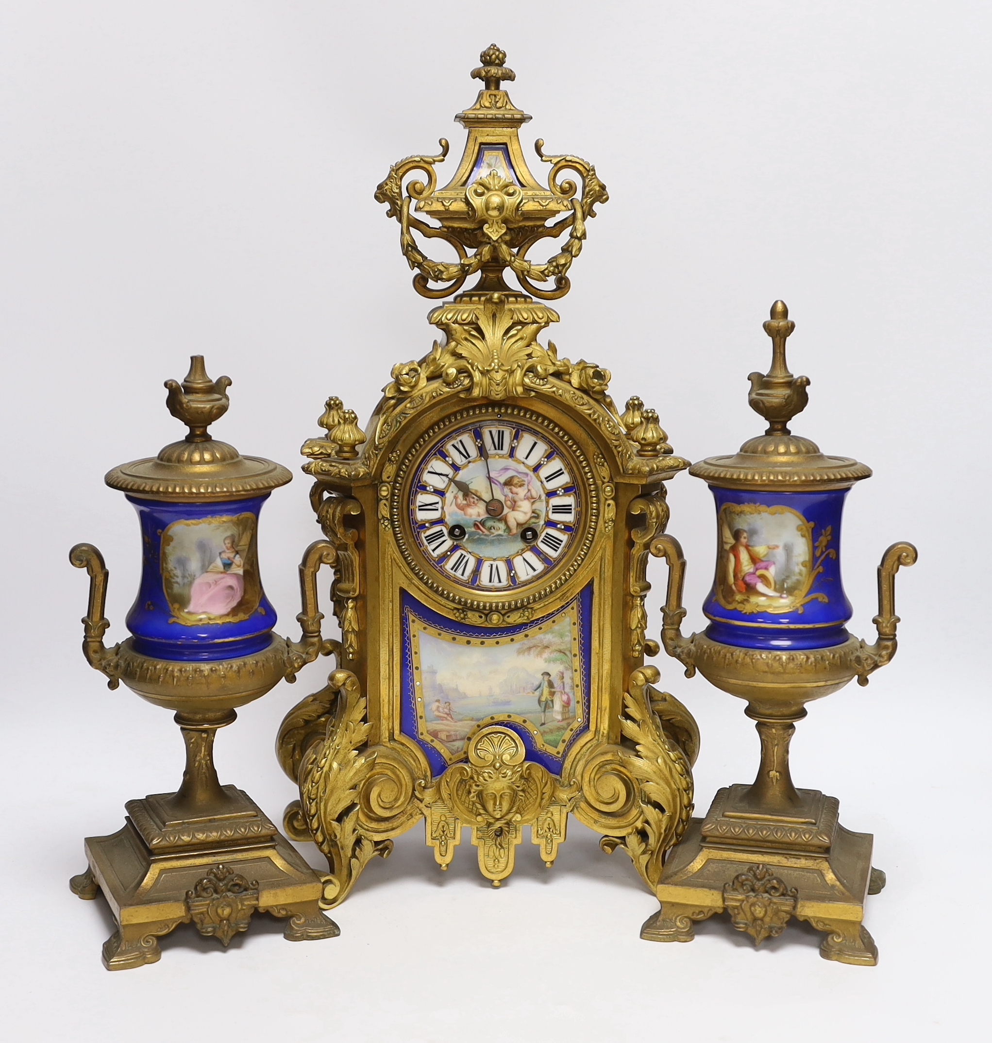 A Sevres style ormolu clock, Miller & Sons with two similar gilt spelter urns, pendulum no key, 44cm